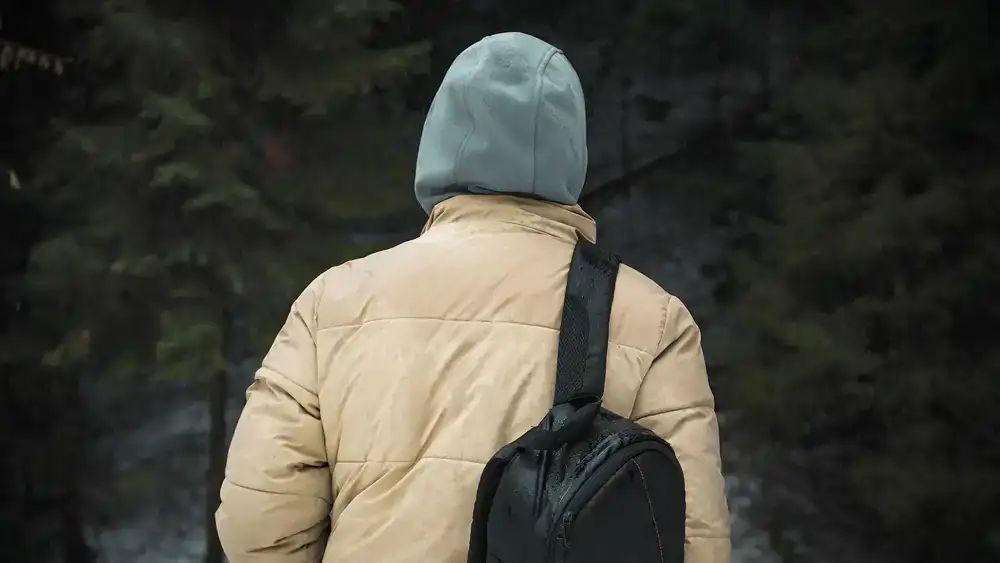Climber wearing bright waterproof jacket