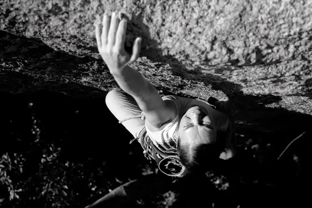 Climber scaling a steep rock face