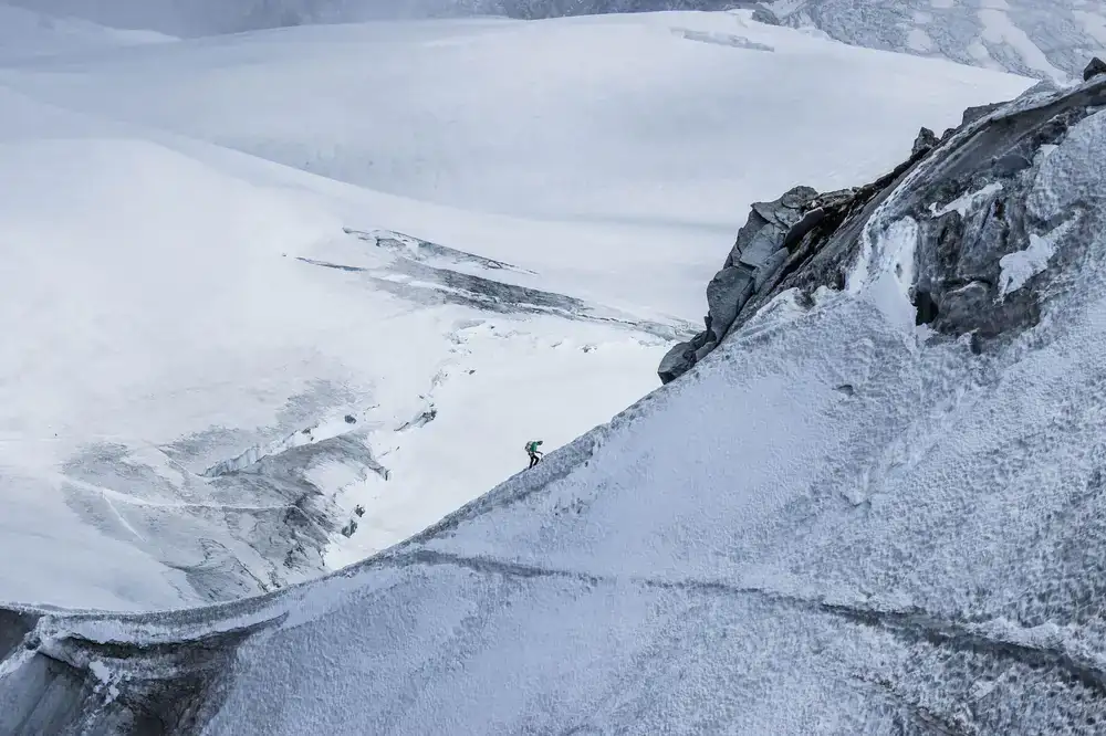 Climber on a steep alpine ridge